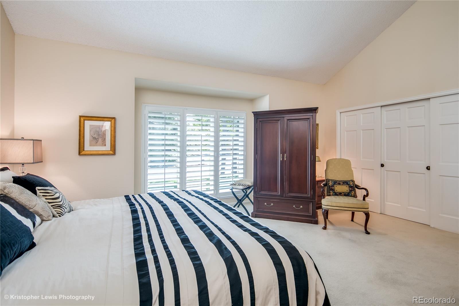 8247 Lodgepole Trail Lone Tree, CO 80124 - Photo 19 of 35 a bedroom with a bed and wooden floor