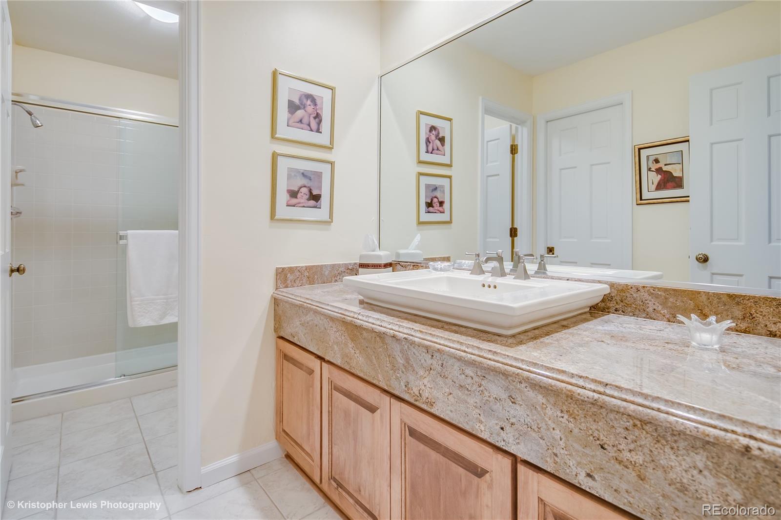 8247 Lodgepole Trail Lone Tree, CO 80124 - Photo 22 of 35 a bathroom with a granite countertop sink and a mirror