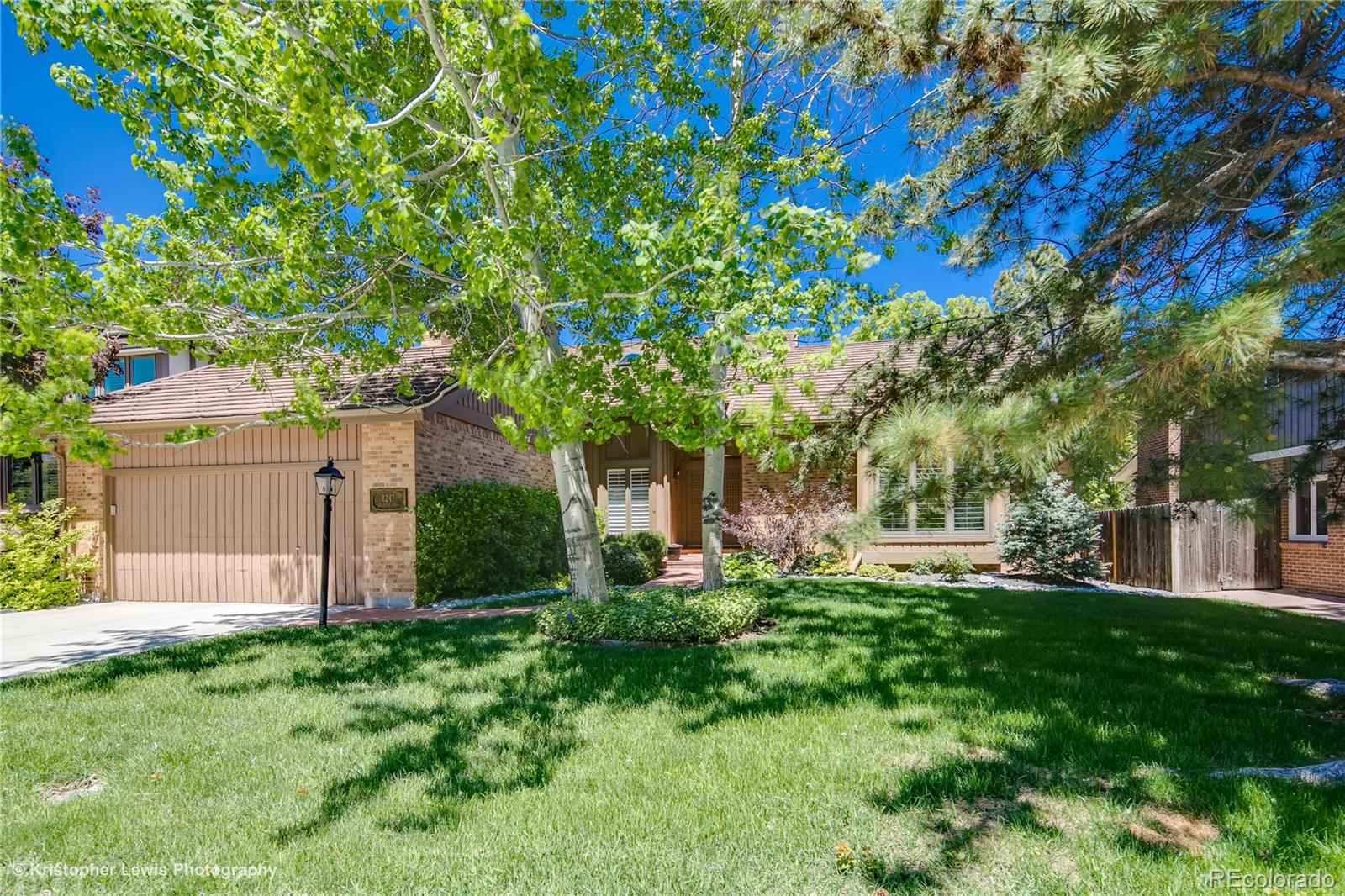 8247 Lodgepole Trail Lone Tree, CO 80124 - Photo 3 of 35 a front view of a house with a yard and tree