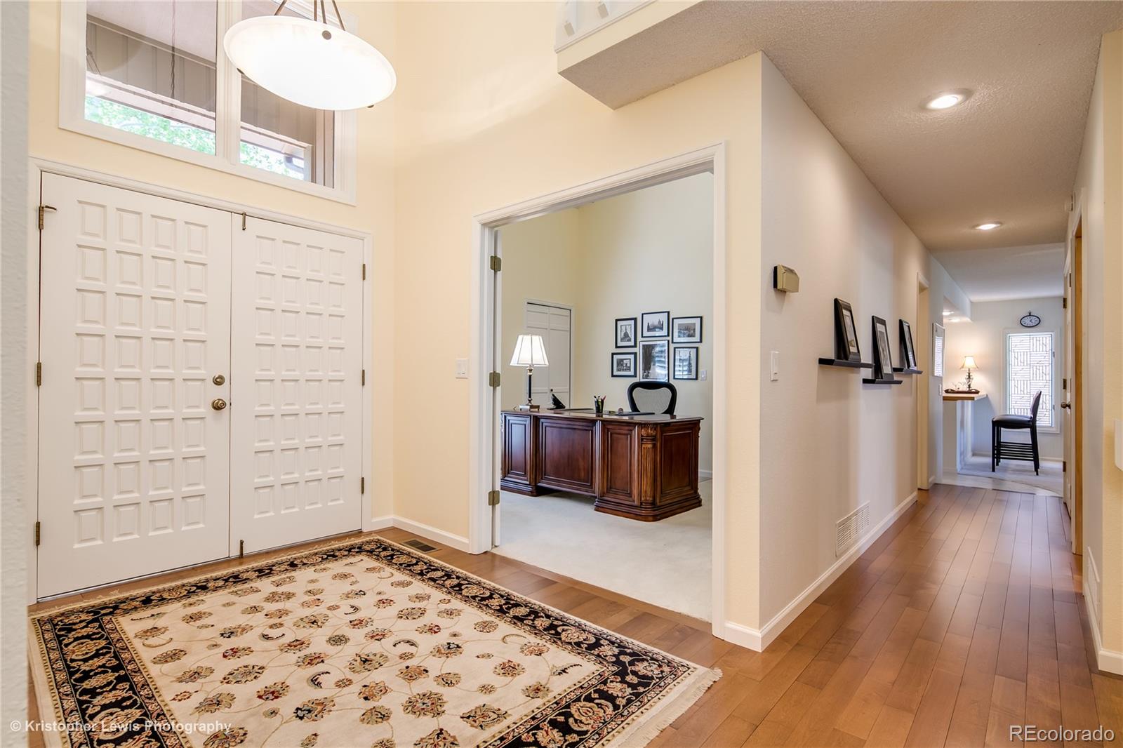 8247 Lodgepole Trail Lone Tree, CO 80124 - Photo 5 of 35 hallway with wooden floor and furniture