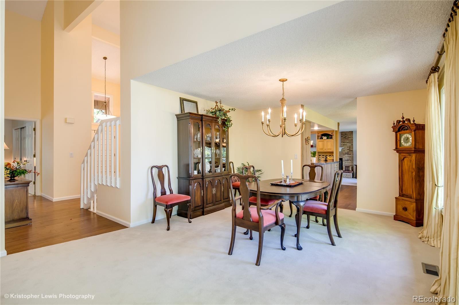 8247 Lodgepole Trail Lone Tree, CO 80124 - Photo 7 of 35 a view of a dining room with furniture and chandelier