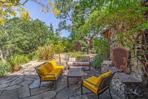 a backyard of a house with table and chairs