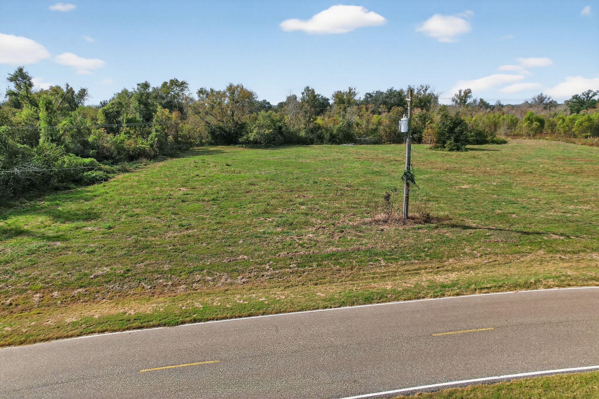 22818 Pittman Drive Angleton, TX 77515 - Photo 4 of 9 a view of a lake with a yard