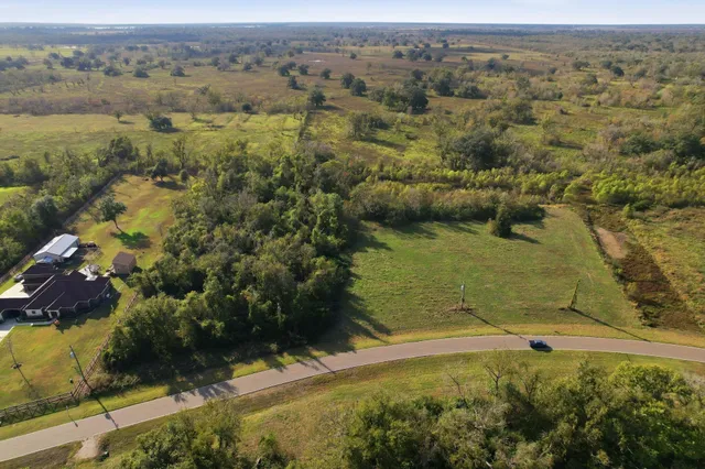 an aerial view of a houses with a yard