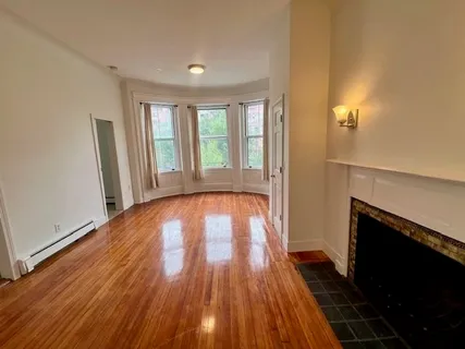 a kitchen with a stove and white cabinets