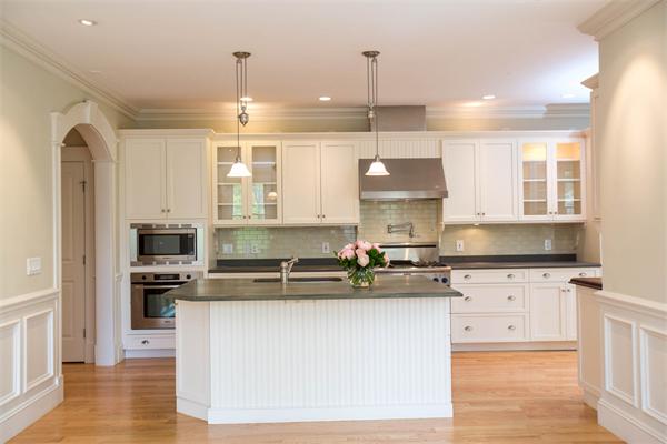 245 Glen Road Weston, MA 02493 - Photo 8 of 26 a kitchen with kitchen island a counter space a sink and appliances