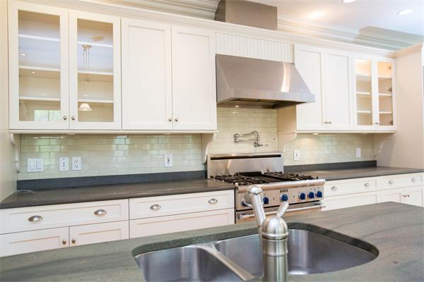245 Glen Road Weston, MA 02493 - Photo 9 of 26 a kitchen with granite countertop a stove a sink and a white cabinets