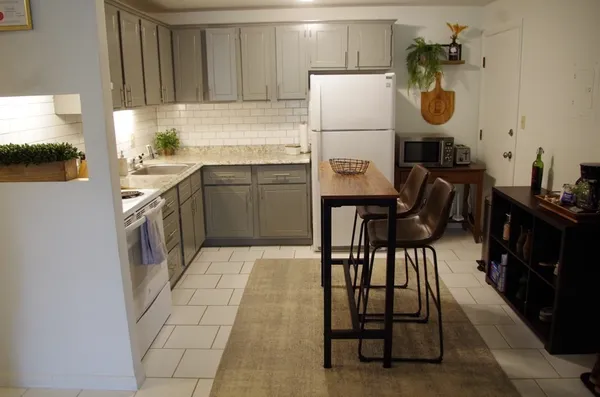 a kitchen with a sink appliances and cabinets