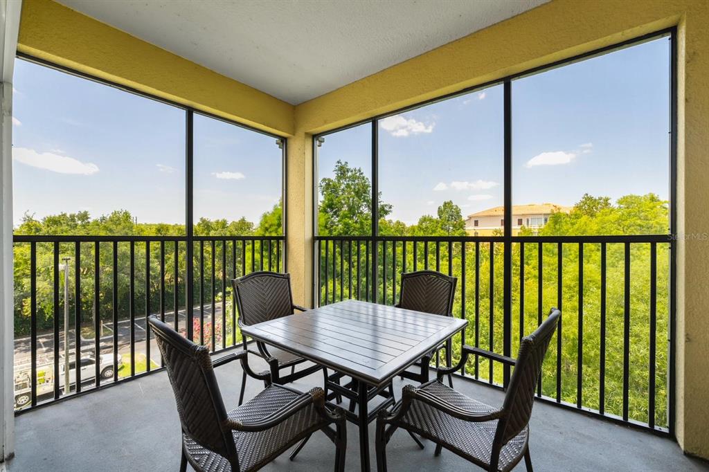 8763 Worldquest Boulevard, Unit 5406 Orlando, FL 32821 - Photo 2 of 25 a view of a balcony with a table and chairs