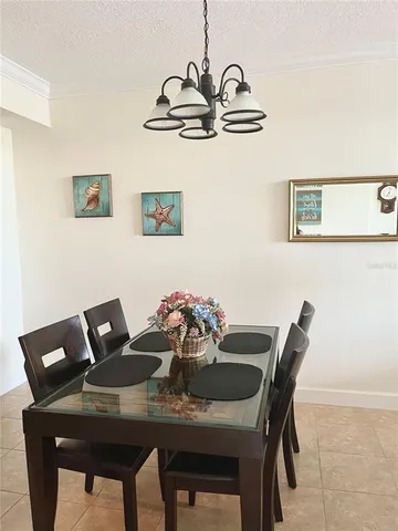 a view of a dining room with furniture and chandelier