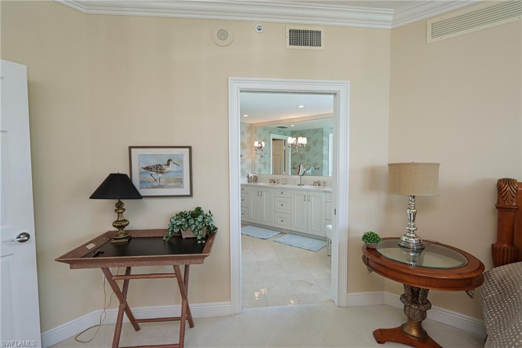 60 Seagate Drive, Unit 402 Naples, FL 34103 - Photo 13 of 26 a view of a workspace room with furniture and wooden floor