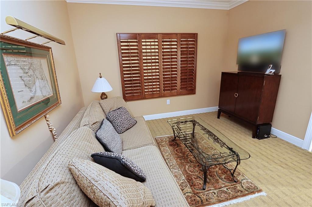60 Seagate Drive, Unit 402 Naples, FL 34103 - Photo 21 of 26 a living room with furniture and a window