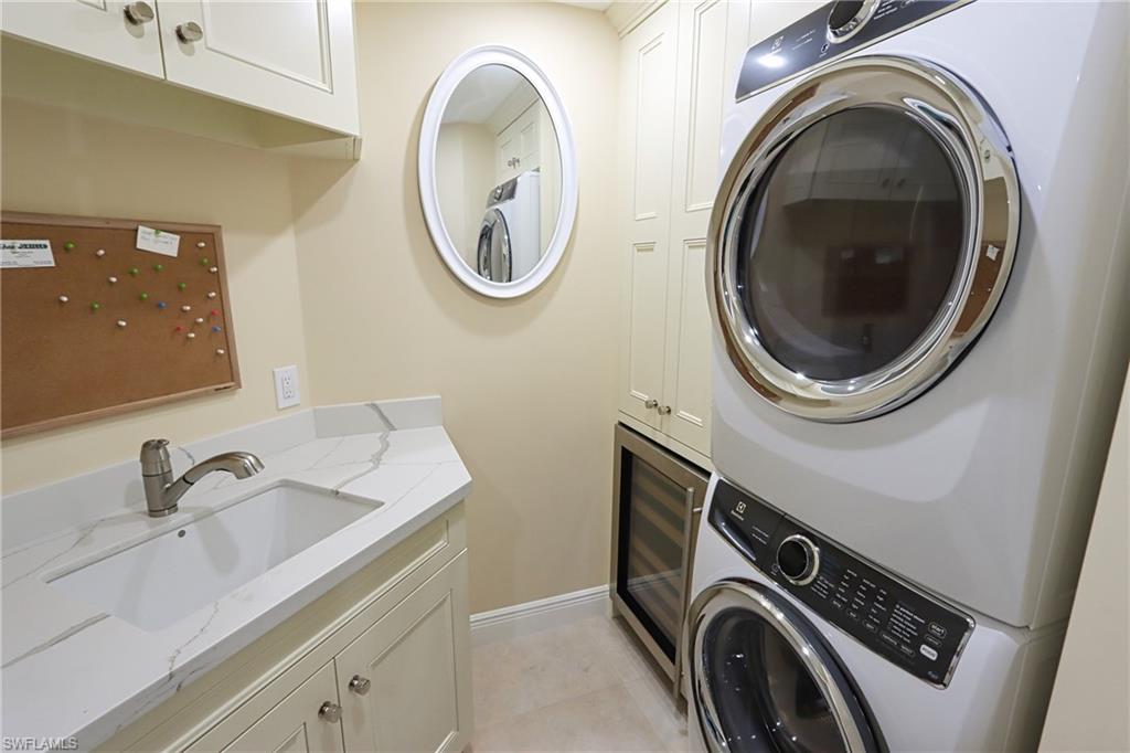 60 Seagate Drive, Unit 402 Naples, FL 34103 - Photo 23 of 26 a utility room with dryer and washer