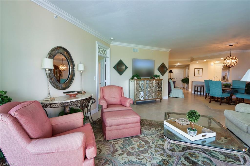 60 Seagate Drive, Unit 402 Naples, FL 34103 - Photo 6 of 26 a living room with furniture and a wooden floor