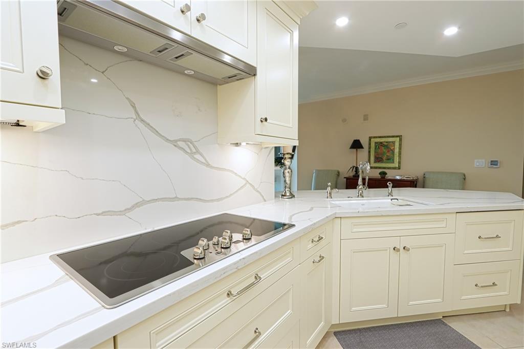 60 Seagate Drive, Unit 402 Naples, FL 34103 - Photo 9 of 26 a bathroom with a sink a vanity and a mirror
