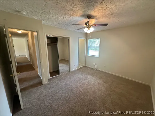 a bathroom with a toilet and a window