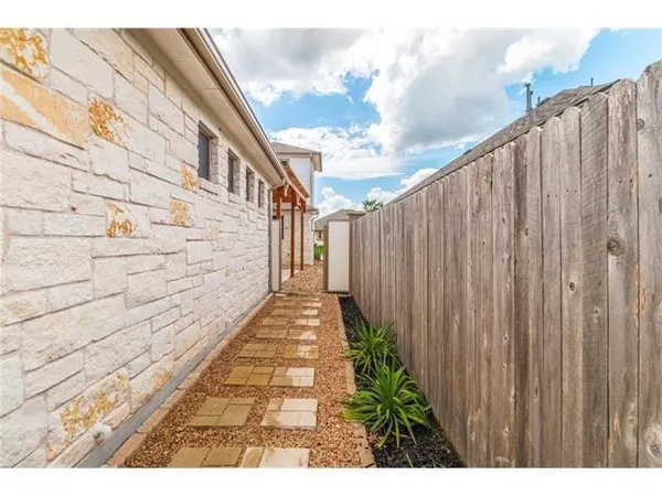 a view of a pathway with a wooden fence