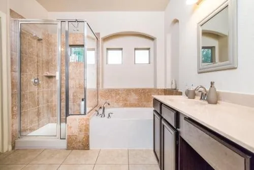 a spacious bathroom with a tub shower and sink