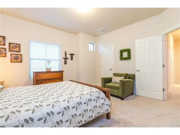 a bedroom with a bed and a couch