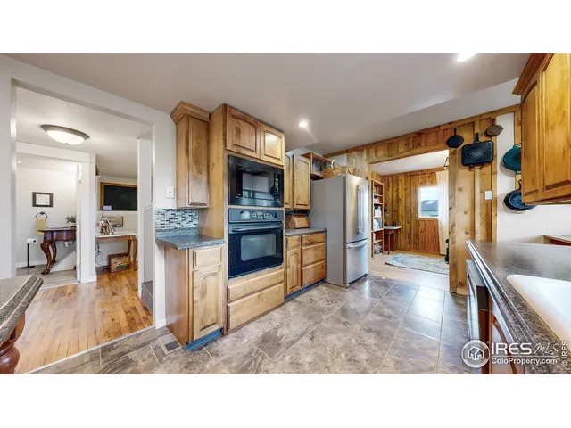a kitchen with sink and refrigerator