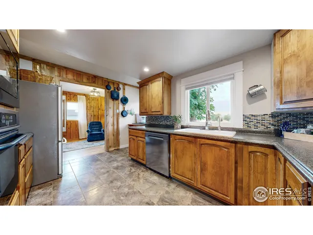 a living room with furniture a rug and a large window