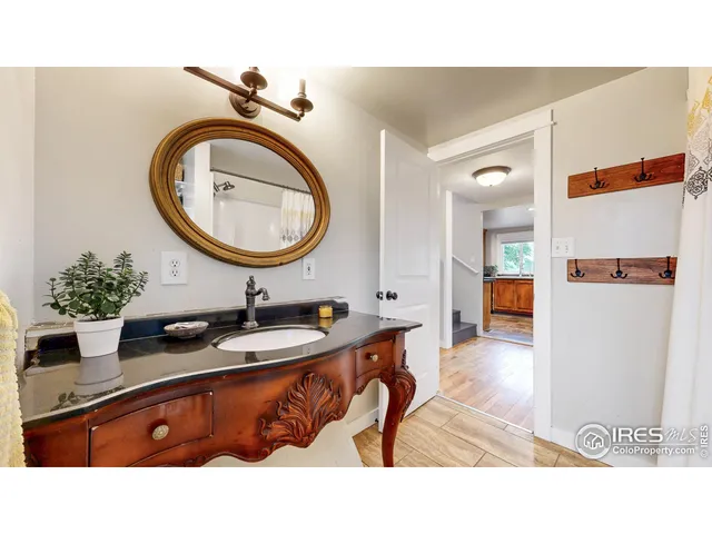 a bathroom with a sink mirror and a toilet