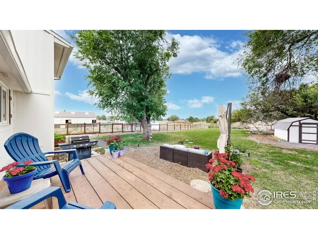 a living room with furniture and a dining table with wooden floor