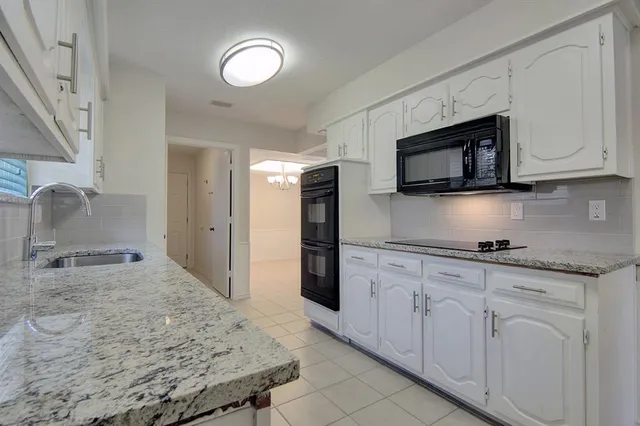 a kitchen with cabinets appliances and a counter space