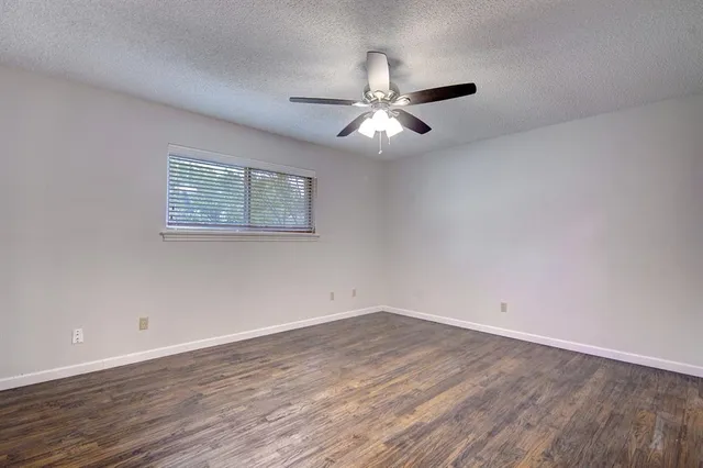 a view of a room with wooden floor and windows