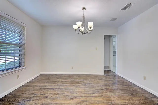 an empty room with wooden floor