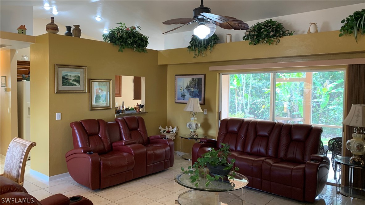 9116 Irving Road Fort Myers, FL 33967 - Photo 7 of 21 a living room with furniture fireplace and a large window