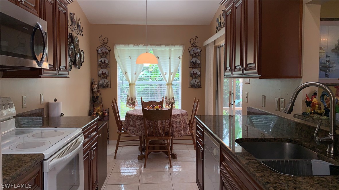 9116 Irving Road Fort Myers, FL 33967 - Photo 8 of 21 a kitchen with a sink and a stove top oven