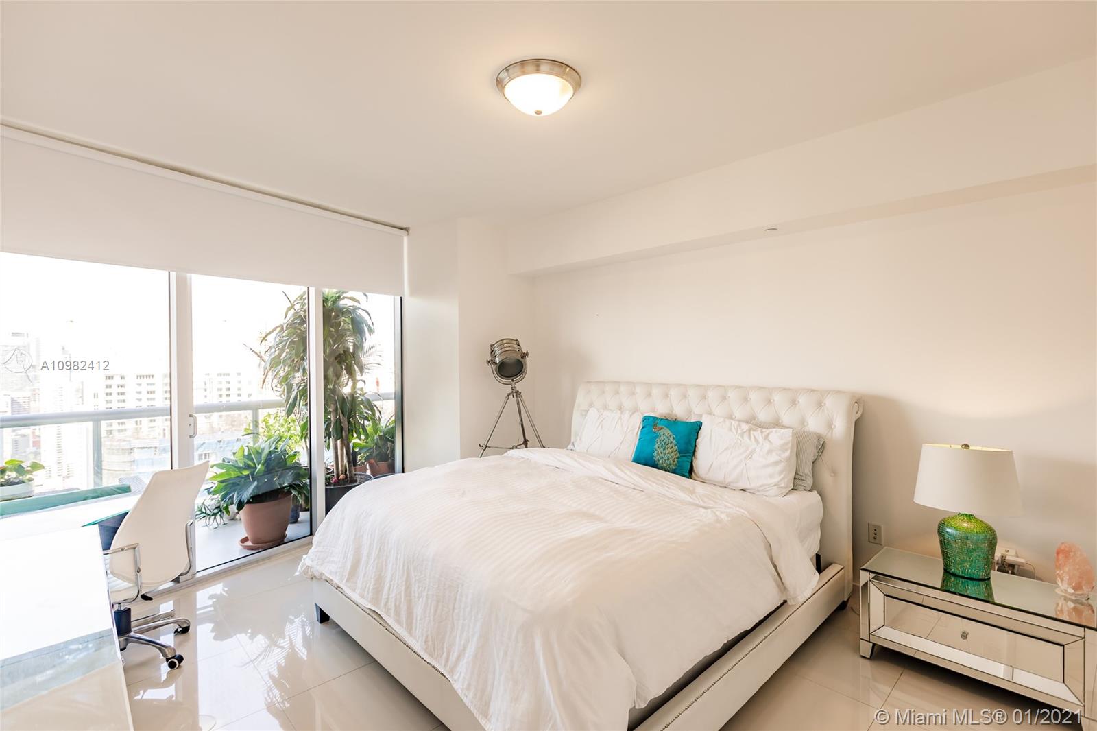 475 Brickell Avenue, Unit 4812 Miami, FL 33131 - Photo 12 of 26 a bedroom with a large bed and a window