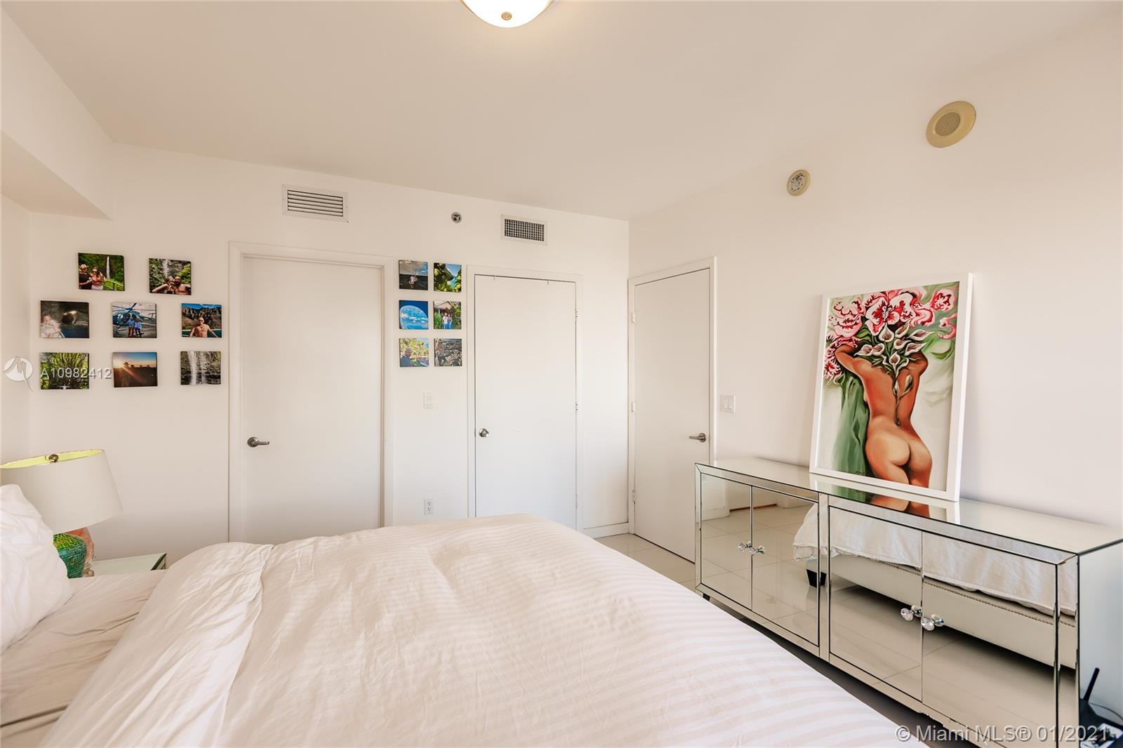 475 Brickell Avenue, Unit 4812 Miami, FL 33131 - Photo 13 of 26 a bedroom with a bed and cabinets