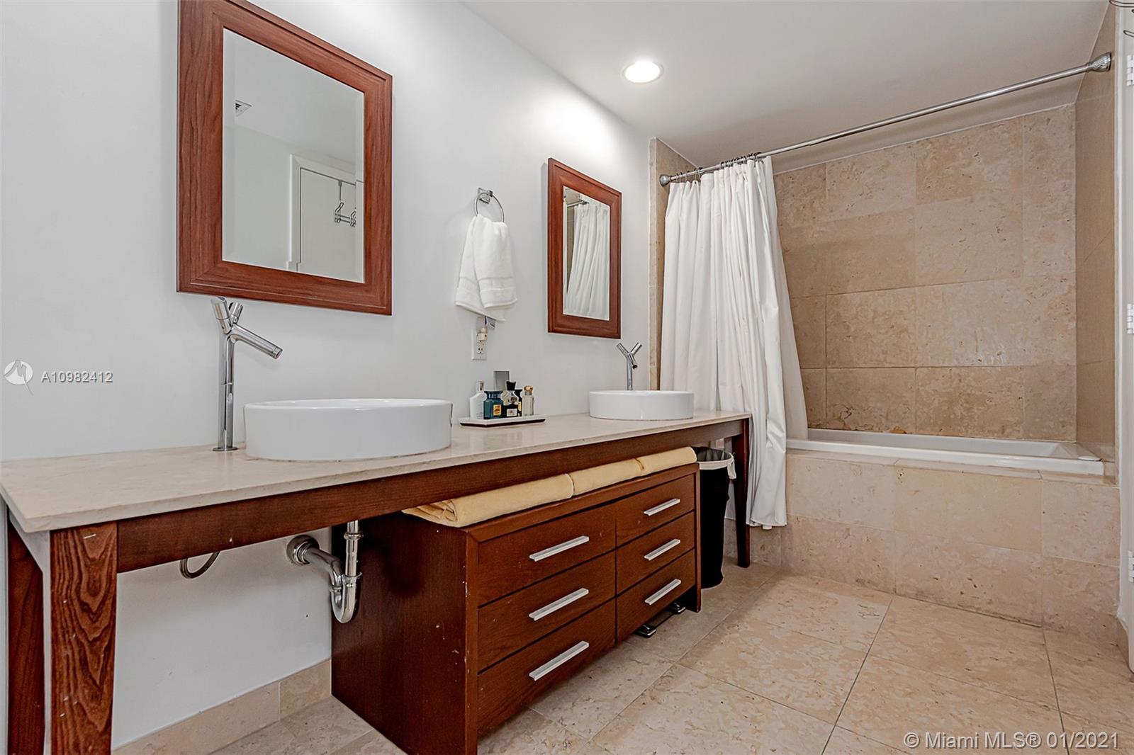 475 Brickell Avenue, Unit 4812 Miami, FL 33131 - Photo 15 of 26 a bathroom with a sink and a mirror