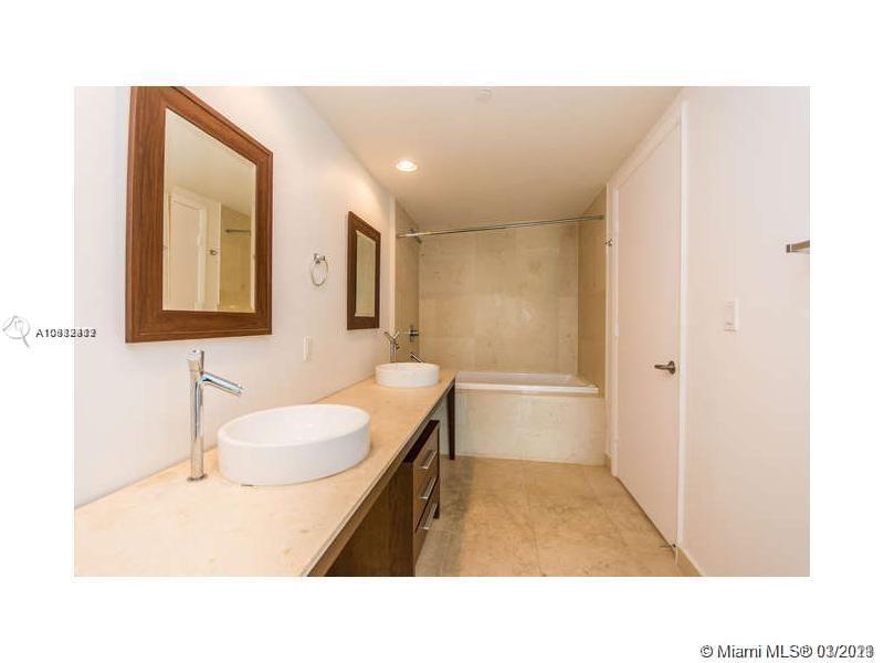 475 Brickell Avenue, Unit 4812 Miami, FL 33131 - Photo 16 of 26 a bathroom with a sink a toilet a mirror and vanity