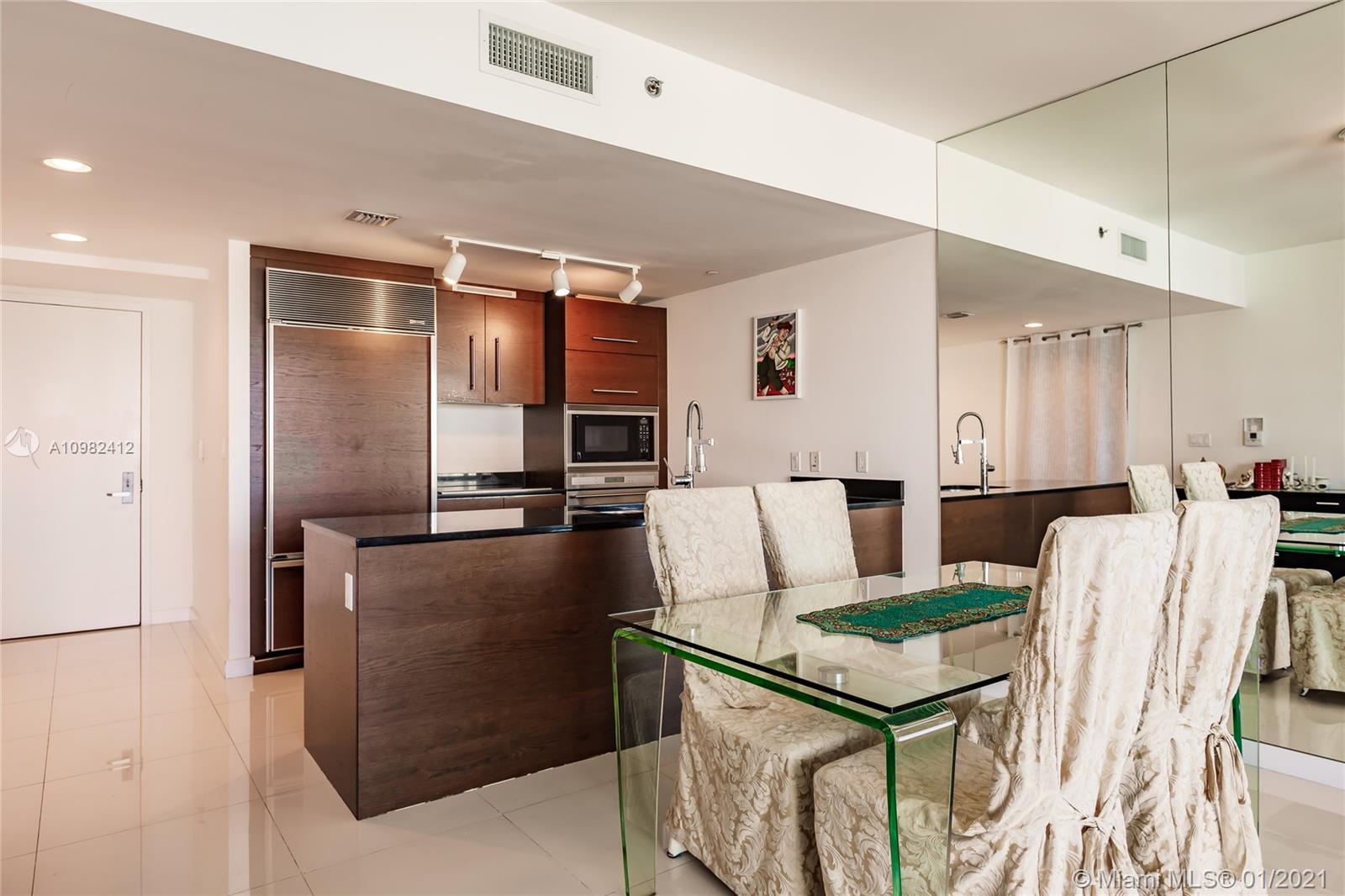 475 Brickell Avenue, Unit 4812 Miami, FL 33131 - Photo 6 of 26 a living room with stainless steel appliances kitchen island granite countertop furniture and a refrigerator