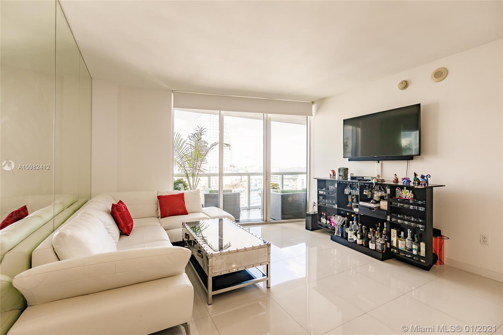 475 Brickell Avenue, Unit 4812 Miami, FL 33131 - Photo 7 of 26 a living room with furniture and a flat screen tv