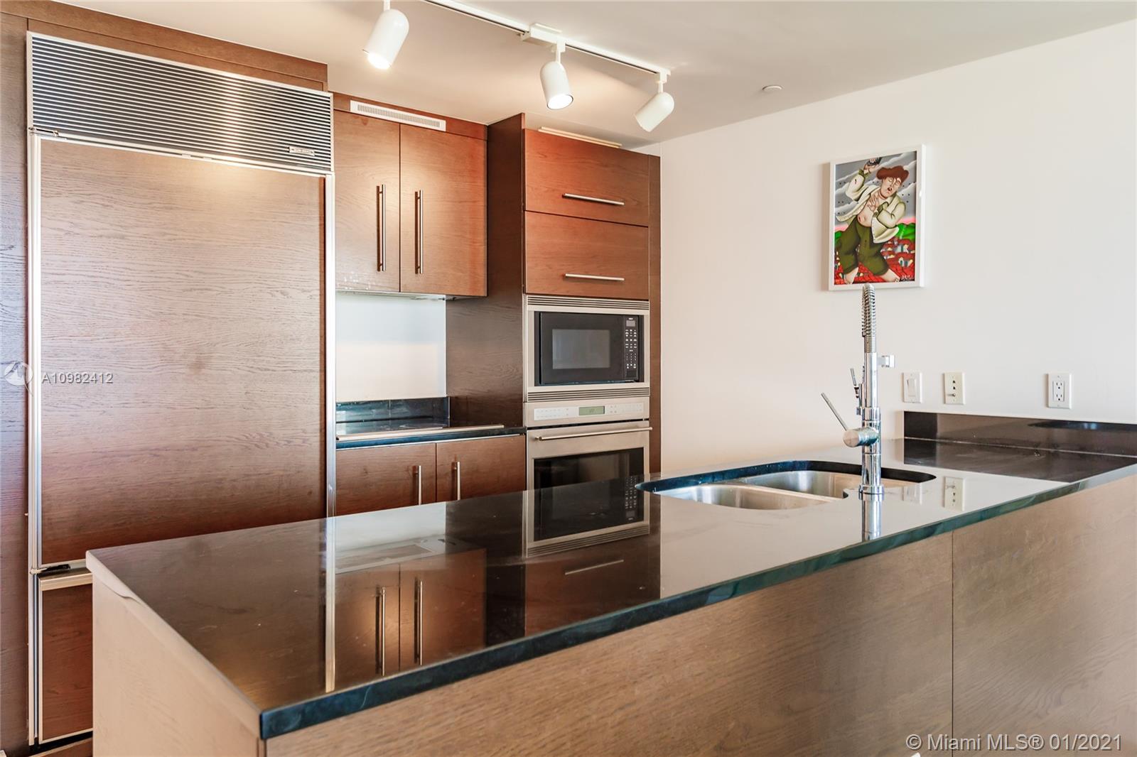 475 Brickell Avenue, Unit 4812 Miami, FL 33131 - Photo 9 of 26 a kitchen with stainless steel appliances granite countertop a refrigerator and a sink
