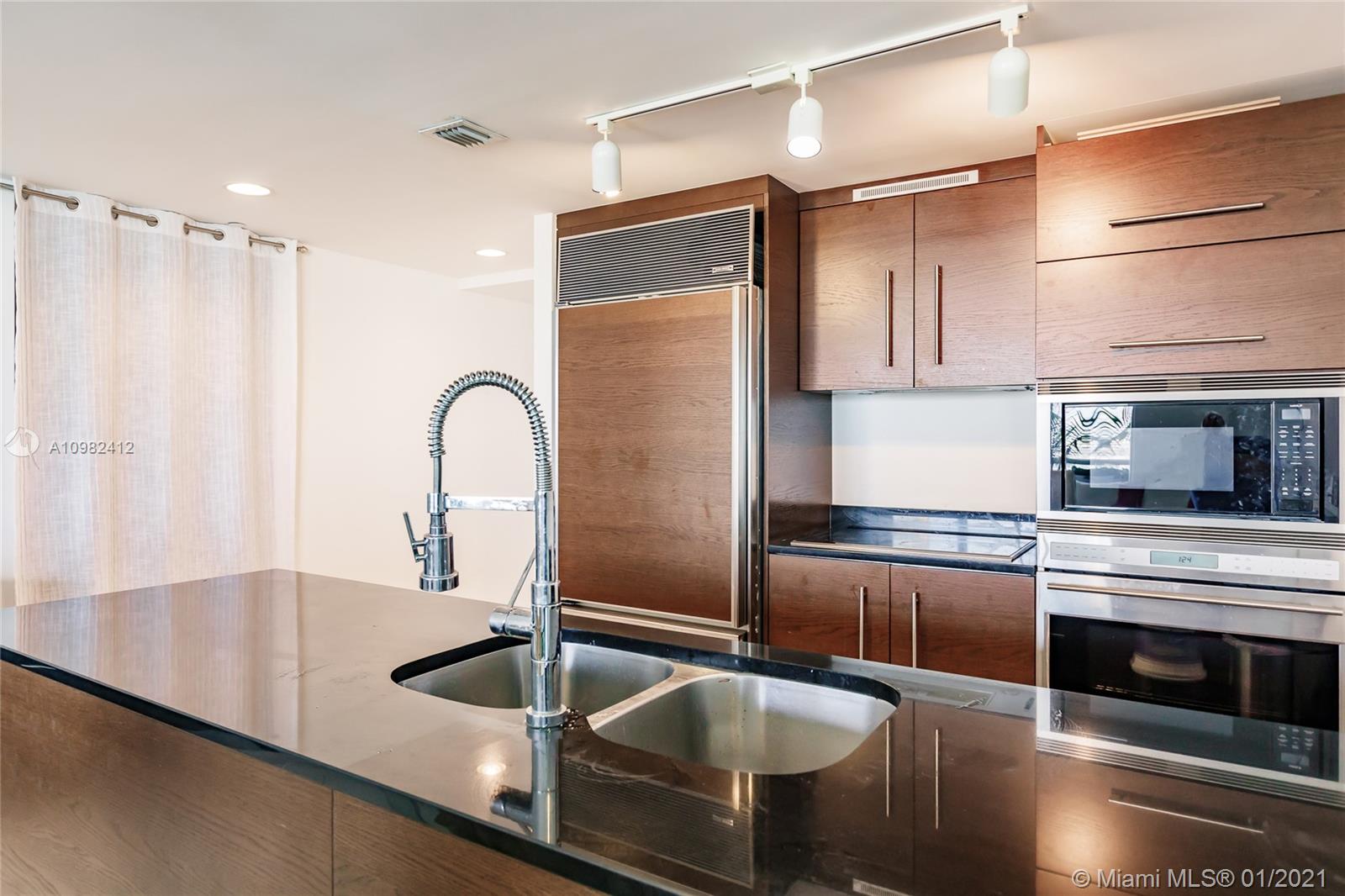 475 Brickell Avenue, Unit 4812 Miami, FL 33131 - Photo 10 of 26 a kitchen with granite countertop a sink and refrigerator