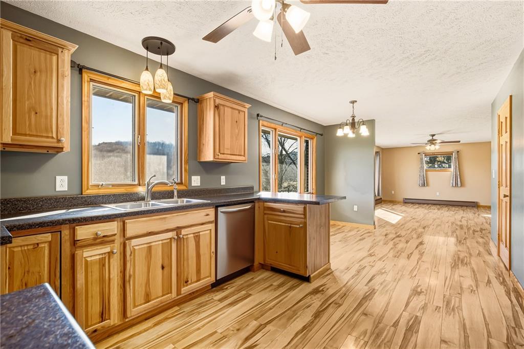 1303 Faidley Road Garrett, PA 15542 - Photo 11 of 43 a large kitchen with stainless steel appliances granite countertop a stove a sink dishwasher and a refrigerator with wooden floor