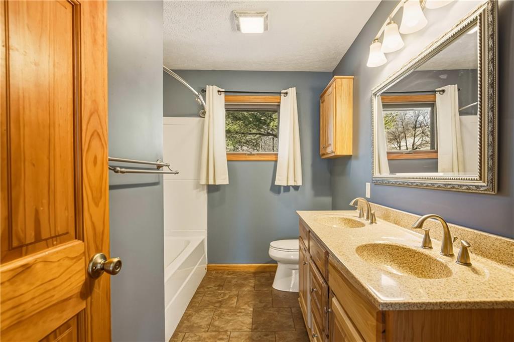1303 Faidley Road Garrett, PA 15542 - Photo 14 of 43 a bathroom with a granite countertop sink toilet and shower