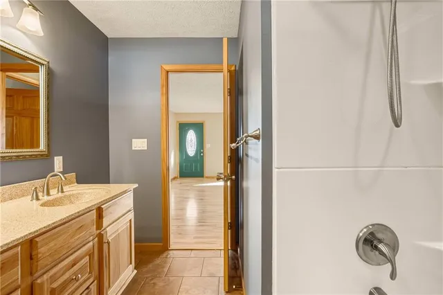 a spacious bathroom with a shower and a sink
