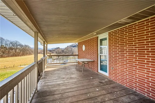 a view of a balcony with wooden floor