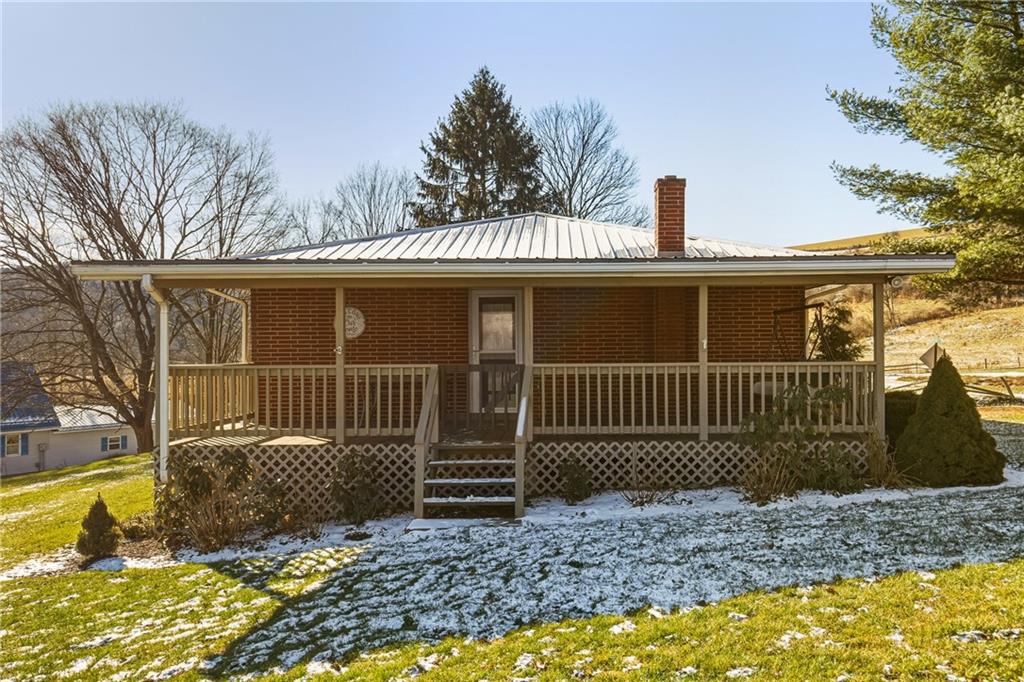 1303 Faidley Road Garrett, PA 15542 - Photo 25 of 43 a view of a house with a small yard and wooden fence