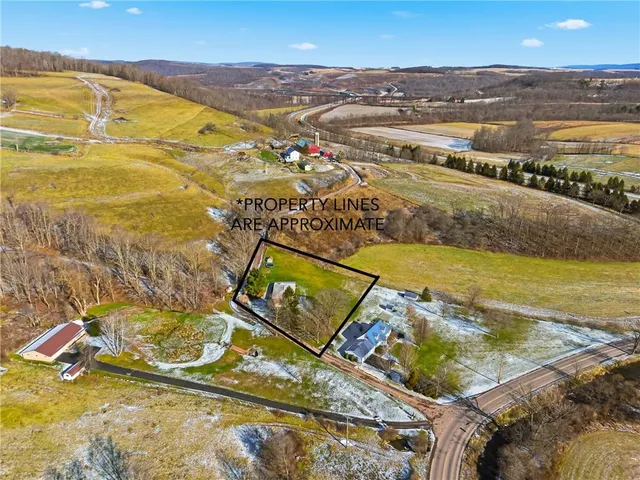 a view of a big yard with swimming pool and mountains