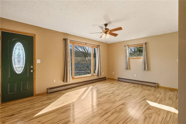 a view of a room with wooden floor and window