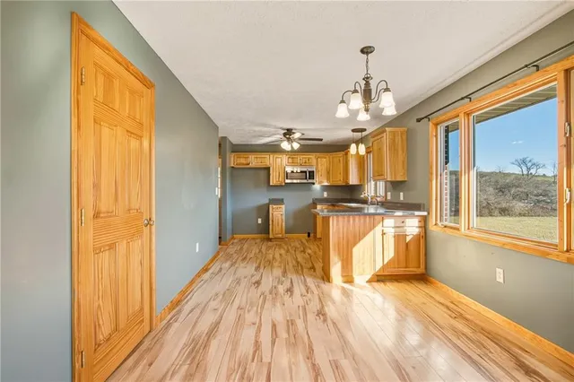 a view of large kitchen with wooden floor and windows