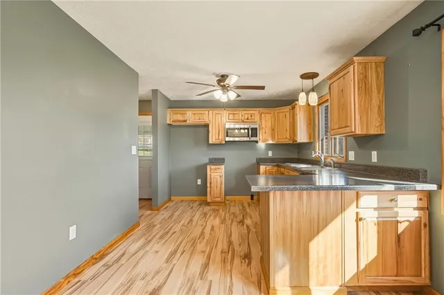 a kitchen with stainless steel appliances granite countertop a sink and a cabinets