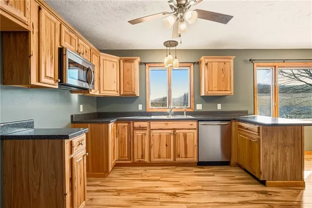 a kitchen with stainless steel appliances granite countertop a sink and cabinets